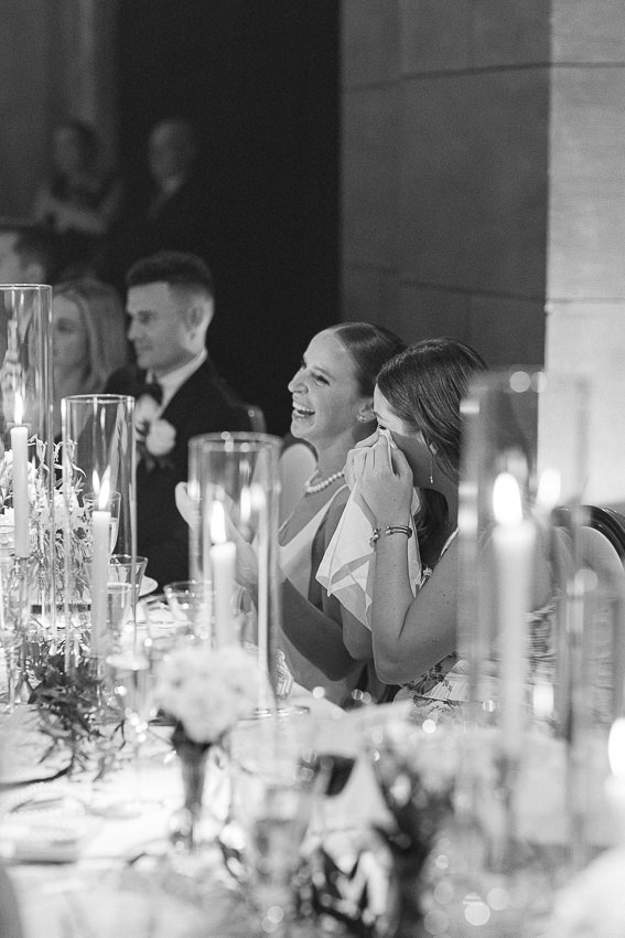 La mariée est heureuse, assise à la table d'honneur.